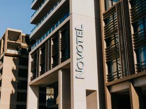 a sign on the side of a building at Novotel Newcastle Beach in Newcastle