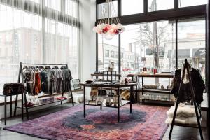 a clothing store with racks of clothes on display at Hotel Covington Cincinnati Riverfront in Covington