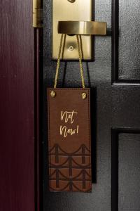 a doorhandle with a not new sign on it at Hotel Covington Cincinnati Riverfront in Covington