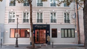 a building with a sign on the front of it at Joli Môme in Paris