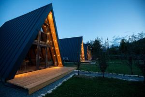 a house with a triangular roof and a wooden deck at A-Park Bologa in Bologa +14 photos