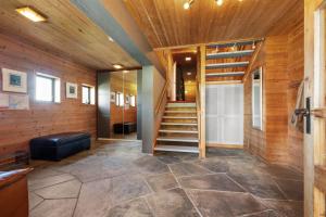 a hallway with a staircase in a wooden house at Skyline View - Nordic Villa Above Bergen in Bergen +40 photos
