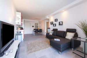 a living room with a couch and a flat screen tv at Casa Laura Apt 3 in Menaggio