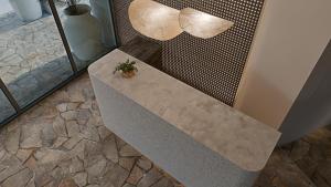a concrete bench with a potted plant on it at Grecale Filoxenia in Vrachonisída touArchangélou +49 photos