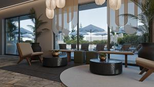 a lobby with tables and chairs and windows at Grecale Filoxenia in Vrachonisída touArchangélou