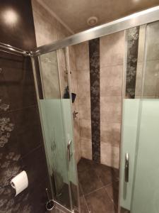 a shower with a glass door in a bathroom at Apartment in the Center 2 in Varna City +15 photos