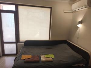 a bed in a room with two towels on it at Apartment in the Center 2 in Varna City