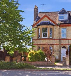 a brick house with a white door on a street at The Forest- Greenwood in Cambridge