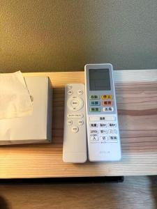a remote control sitting on a shelf next to a box at star in Osaka