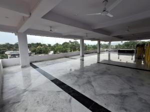 an empty room with a large room with a ceiling at Om Siya Ram Resort in Rājgīr