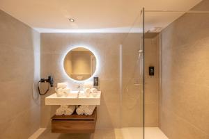 a bathroom with a shower and a sink and a mirror at Résidence San Petru - 4 étoiles in Porto-Vecchio +54 photos