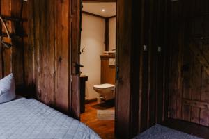 a bedroom with a bed and a bathroom with a toilet at Wysoka 5 in Szklarska Poręba +38 photos