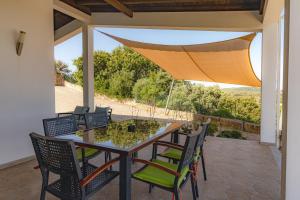 a table and chairs on a patio with a view at Villa Belchior by Algarve Holidays in Faro