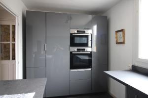 a kitchen with a refrigerator and a stove at La Chandeler in Juvigny-sous-Andaine