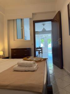 a bedroom with a bed with towels on it at EverBlue Suites - Halkidiki Beachfront in Psakoudia