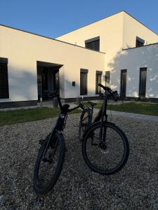 two bikes parked in front of a building at Kolokán Apartmanhàz in Tiszafüred