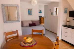 a room with a table with a bowl of fruit on it at Quinta Cabecinha in Penela