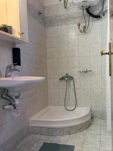 a bathroom with a sink and a shower and a toilet at EverBlue Suites - Halkidiki Beachfront in Psakoudia