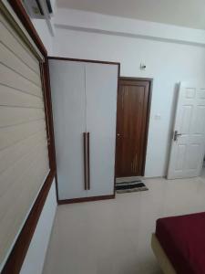 an empty garage with a door in a room at Kalpaka lee divine in Guruvāyūr +2 photos