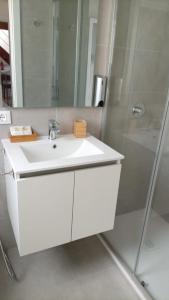 a bathroom with a white sink and a shower at Argenteria5 Holiday Rooms in Palermo +24 photos