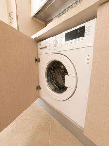 a white washer and dryer in a laundry room at Bukowski Loft House in Porticello
