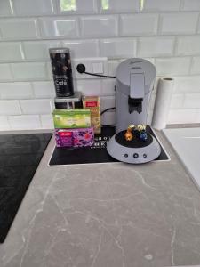 a kitchen counter with a coffee maker and some food at Studio centre-clim-parking privée-rdc in Saint-Gaudens