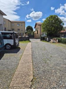 a white van parked on a gravel road at Studio centre-clim-parking privée-rdc in Saint-Gaudens
