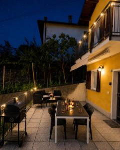 a table and chairs on a patio at night at Casa Sophie in Consiglio di Rumo