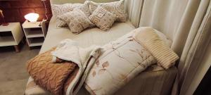 a bed with pillows on it in a room at Espaço Vintage Hospedaria Suíte Alento in Prados +93 photos