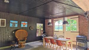 a room with a table and chairs and a fireplace at Landhuis onder de lindeboom in Losser