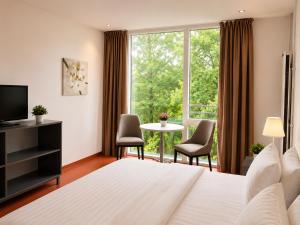 a hotel room with a bed and a large window at Hótel Bifröst in Bifrost