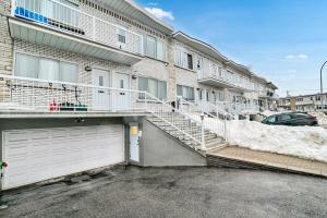 a parking lot in front of a building with a garage at Elegance comfort à Montreal in Montreal +8 photos