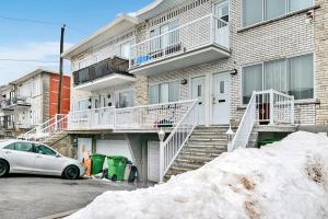 a house with a car parked in front of it at Elegance comfort à Montreal in Montreal