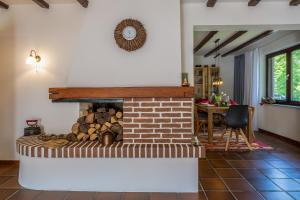 a brick fireplace in a living room with a table at Ferienwohnung KOTE in Dannenberg +49 photos