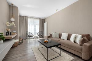 a living room with a couch and a table at Perfect Holiday Apartments Bel Mare by Noclegi Renters in Międzyzdroje