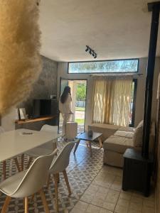 a woman is standing in a living room at Calma in Miramar