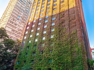 a tall building with ivy on the side of it at Sofitel Buenos Aires Recoleta in Buenos Aires