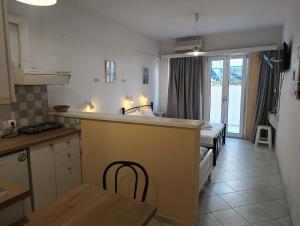 a kitchen with a sink and a bed in a room at Renia Studios - Pool & Beach in 150m - Agia Pelagia in Agia Pelagia