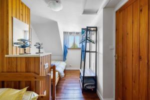 a room with a room with a ladder and a bed at La Poya in Plonévez-du-Faou