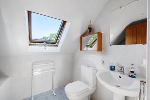 a bathroom with a toilet and a sink at La Poya in Plonévez-du-Faou +15 photos