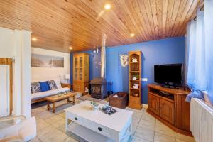 a living room with a couch and a tv at La Poya in Plonévez-du-Faou