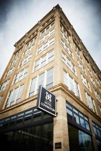 a tall building with a sign in front of it at Hotel Covington Cincinnati Riverfront in Covington
