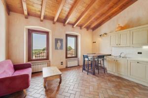 a kitchen with a couch and a table in a room at Casa Dolca Casa La Torre in Pozzolengo +15 photos
