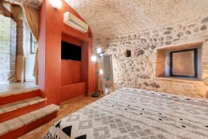 a bedroom with a large bed in a stone wall at Casa Dolca Casa La Torre in Pozzolengo