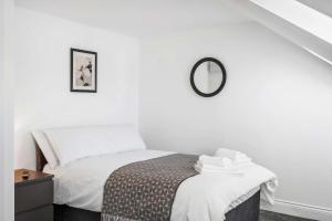 a bedroom with a bed with a mirror on the wall at Large 6-Bed House - 5 Bathrooms w Free Parking by StaySejour in Sompting