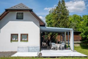 a white house with a table and chairs at Kouzelný domeček in Ostrava