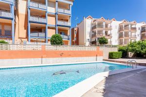 a swimming pool in front of some apartment buildings at Lopimar Aurora in Canet de Berenguer