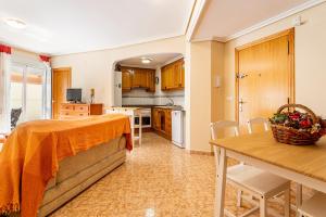 a kitchen with a table and a dining room at Lopimar Aurora in Canet de Berenguer