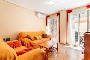 a living room with two couches and a table at Lopimar Aurora in Canet de Berenguer