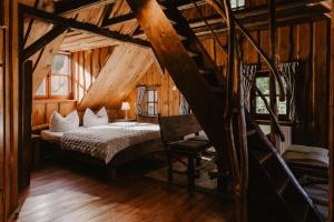 a bedroom with a bed in a wooden cabin at Wysoka 5 in Szklarska Poręba